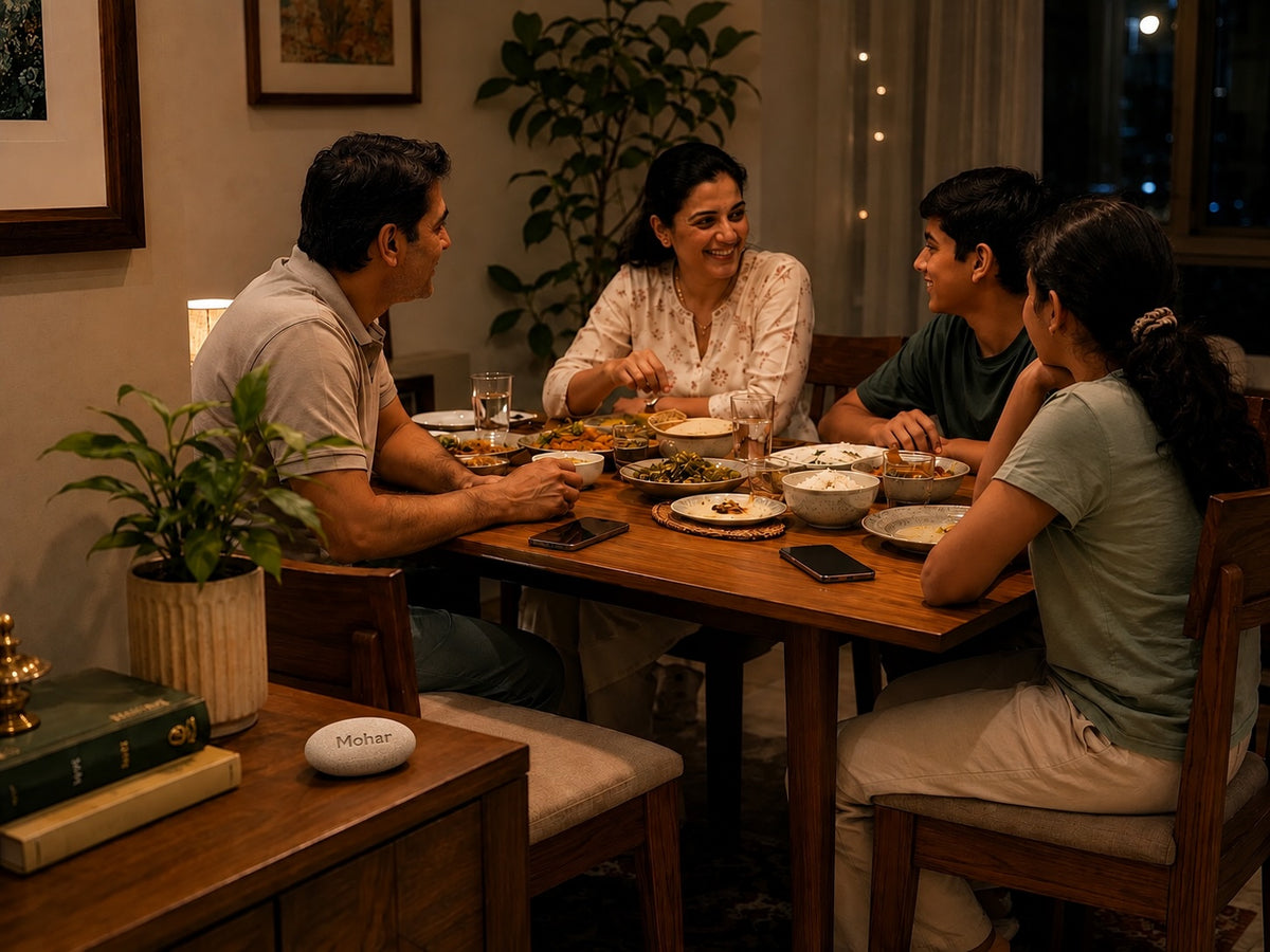 An Indian family eating dinner together with the Mohar on the side table