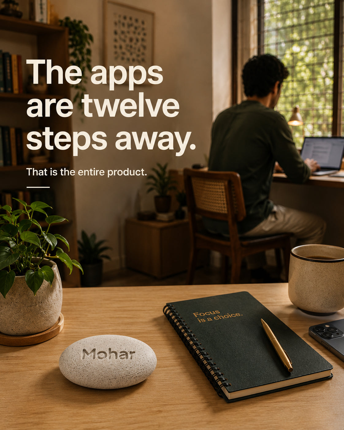 A desk with the Mohar in the foreground and the phone across the room